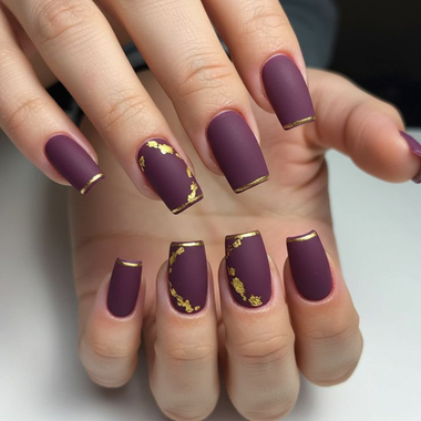 Plum-colored nails with gold