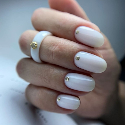 Milky manicure with gold accent