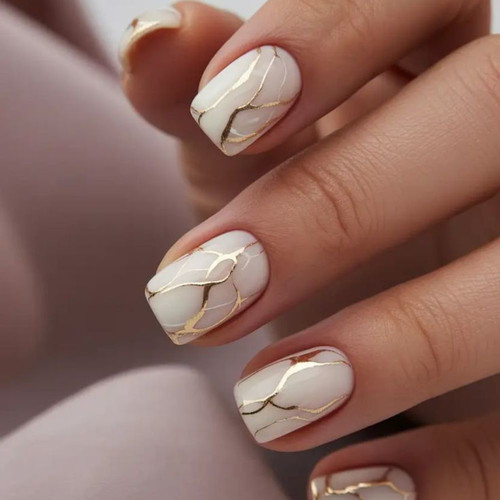 Milky marble manicure with gold veins